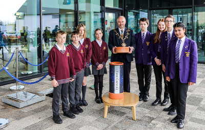 The Mayor of Stockton-on-Tees, Councillor Ross Patterson, alongside the time capsule and pupils from All Saints Secondary School and Myton Park Primary School