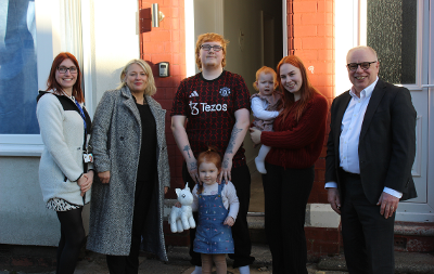 Photo of new tenants outside house in Thornaby with Cllr Nigel Cooke